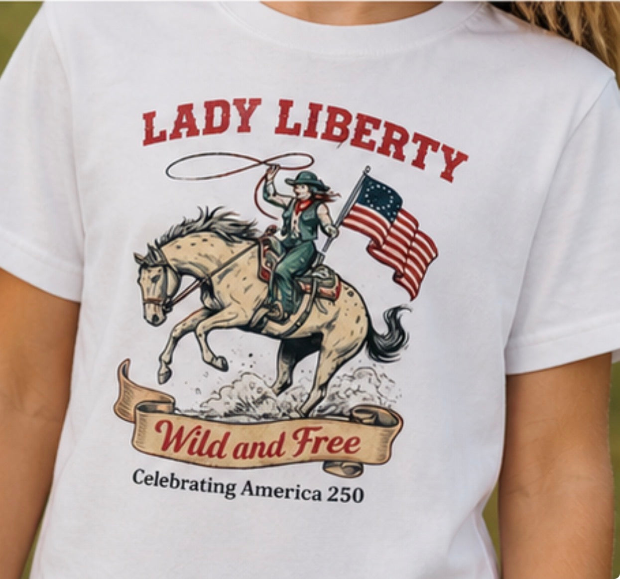 White t-shirt with 'Lady Liberty' graphic featuring a woman on a horse with an American flag.