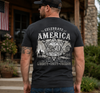 Man wearing a black t-shirt with 'Celebrate America' design outdoors.