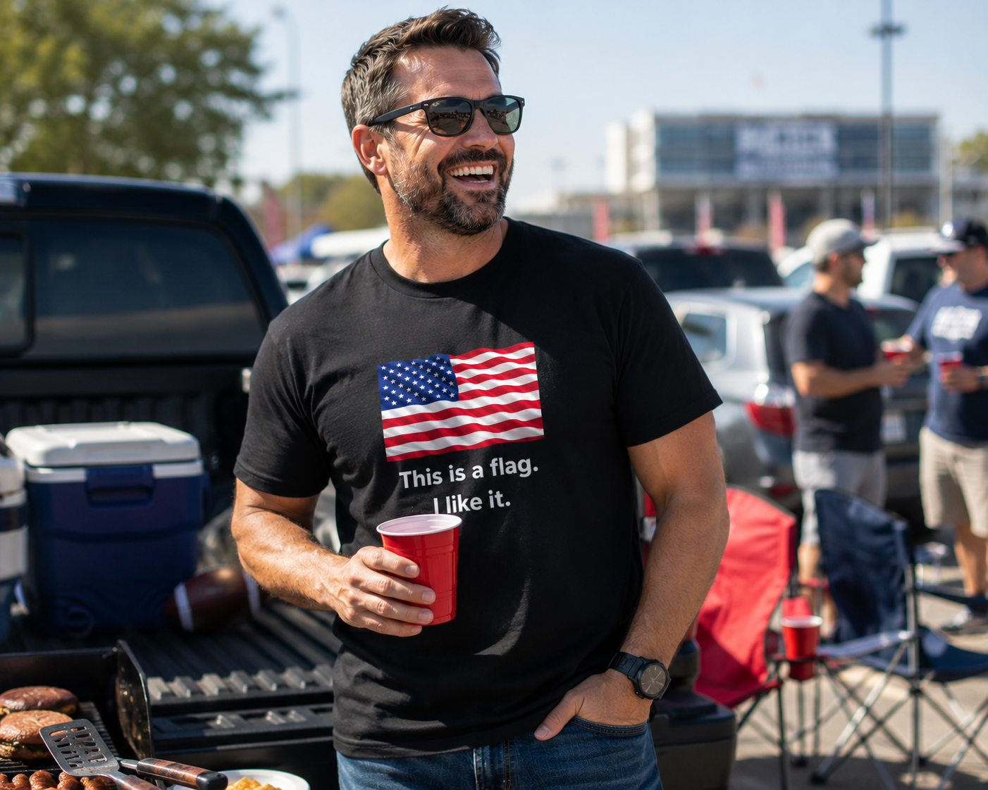 A man wearing a black t-shirt with a graphic of the American flag and the text 'This is a flag. I like it.