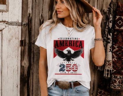 Woman wearing a t-shirt with an eagle graphic and text, standing in front of a wooden wall.