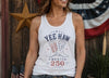 Woman wearing a white tank top with 'Yee Haw America 250' design in front of an American flag.