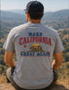 Person wearing a t-shirt with 'Make California Great Again' text and bear graphic, sitting on a hilltop.