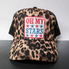 Leopard print cap with 'OH MY STARS' patch on a gray surface