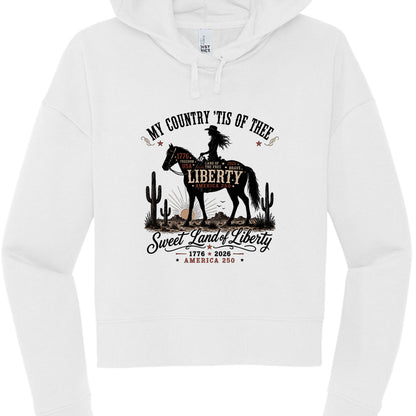 Women's white patriotic cropped hoodie with vintage Western cowboy graphic reading My Country Tis of Thee Sweet Land of Liberty America 250 1776 2026
