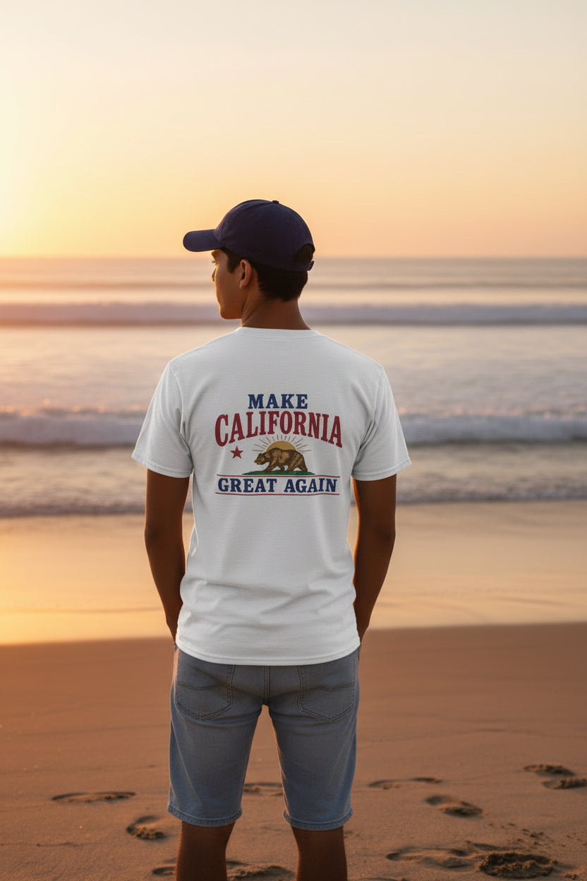 man standing on beach wearing a white make california great again t shirt design on back