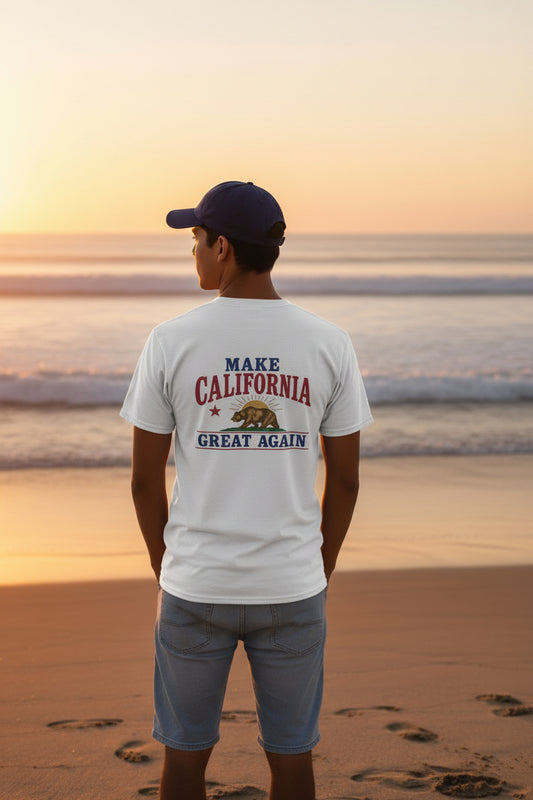 man standing on beach wearing a white make california great again t shirt design on back